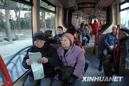 Passengers take a ride in a streetcar in Shanghai on January 1, 2010. [Photo/Xinhua]