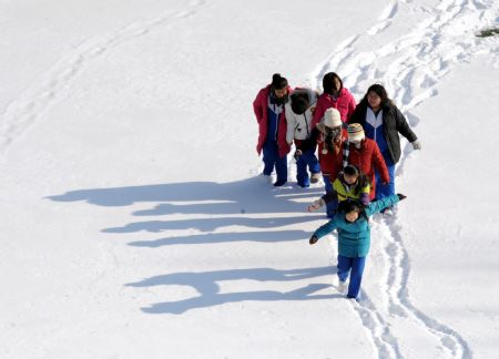 Students have fun on the playground during a break in a school in Beijing, China, Jan. 5, 2010. Classes in primary and secondary schools in Beijing resumed on Tuesday after a one-day suspension due to the heavy snowfall. (Xinhua