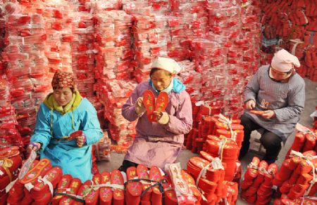 Women make shoe-pads in Yiyuan County of east China's Shandong Province, Jan. 5, 2010. Red shoe-pads, meaning best wishes and good luck, are welcomed as the Chinese lunar new year approaches. 