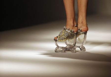 A model displays shoes during the pre-show of World Boutique, Hong Kong in Hong Kong Convention and Exhibition Center, south China, Jan. 5, 2010.