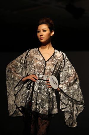 A model displays costume during the pre-show of World Boutique, Hong Kong in Hong Kong Convention and Exhibition Center, south China, Jan. 5, 2010. 