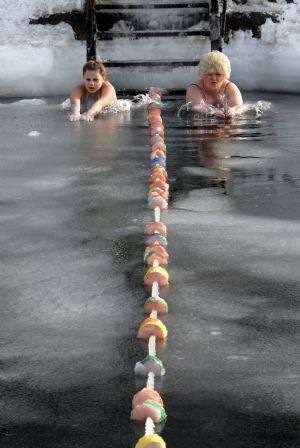 Enthusiasts participate in a winter swimming competition in Vladivostok January 5, 2010. Russian ice swimmers, known as &apos;walruses&apos;, believe that their hobby helps to build up resistance to many illnesses and is crucial for surviving the long winter. [Xinhua/Reuters]