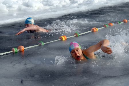 Enthusiasts participate in a winter swimming competition in Vladivostok January 5, 2010. Russian ice swimmers, known as &apos;walruses&apos;, believe that their hobby helps to build up resistance to many illnesses and is crucial for surviving the long winter. [Xinhua/Reuters]