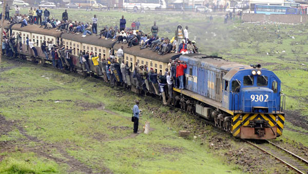 Passengers ride atop overloaded carriages of a commuter train in Kenya&apos;s capital Nairobi, January 5, 2009. Public transport in Kenya&apos;s main cities was paralysed for the second day following a strike by matatu (minibus) drivers and conductors on allegations of extortion and corruption by police. Officials of the drivers and conductors association and the Matatu Welfare Association said the industrial action over harassment by the police would continue unabated. [Xinhua/AFP]