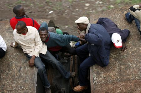 Passengers ride atop overloaded carriages of a commuter train in Kenya&apos;s capital Nairobi, January 5, 2009. Public transport in Kenya&apos;s main cities was paralysed for the second day following a strike by matatu (minibus) drivers and conductors on allegations of extortion and corruption by police. Officials of the drivers and conductors association and the Matatu Welfare Association said the industrial action over harassment by the police would continue unabated. [Xinhua/Reuters] 