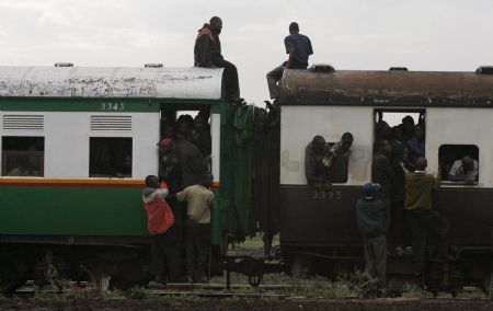 Passengers ride atop overloaded carriages of a commuter train in Kenya&apos;s capital Nairobi, January 5, 2009. Public transport in Kenya&apos;s main cities was paralysed for the second day following a strike by matatu (minibus) drivers and conductors on allegations of extortion and corruption by police. Officials of the drivers and conductors association and the Matatu Welfare Association said the industrial action over harassment by the police would continue unabated. [Xinhua/Reuters] 