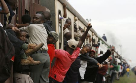 Passengers ride atop overloaded carriages of a commuter train in Kenya&apos;s capital Nairobi, January 5, 2009. Public transport in Kenya&apos;s main cities was paralysed for the second day following a strike by matatu (minibus) drivers and conductors on allegations of extortion and corruption by police. Officials of the drivers and conductors association and the Matatu Welfare Association said the industrial action over harassment by the police would continue unabated. [Xinhua/Reuters] 