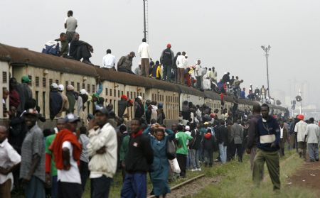 Passengers ride atop overloaded carriages of a commuter train in Kenya&apos;s capital Nairobi, January 5, 2009. Public transport in Kenya&apos;s main cities was paralysed for the second day following a strike by matatu (minibus) drivers and conductors on allegations of extortion and corruption by police. Officials of the drivers and conductors association and the Matatu Welfare Association said the industrial action over harassment by the police would continue unabated. [Xinhua/Reuters] 