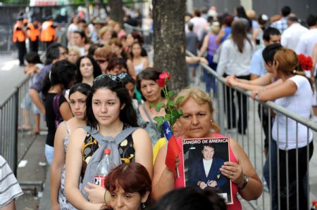 Fans of Argentine pop singer Sandro wait outside the Congress building where his coffin is placed in Buenos Aires on Jan. 5, 2010. Sandro died on the eve in the Argentine city of Mendoza at the age of 64. The singer, whose real name was Roberto Sanchez and known as 'Argentina's Elvis Presley', died on January 4, 2010 at the age of 64 in the central Argentine city of Mendoza. Sandro died from an infection after heart and lung transplant surgery.