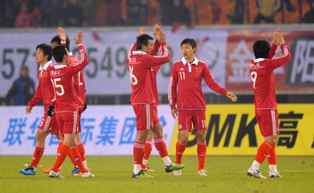 China's players greet the audience after a Group D match of the Asian Cup 2011 Final Qualification Round against Syria in Hangzhou, east China's Zhejiang Province, Jan. 6, 2010.