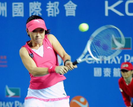 China's Zheng Jie of Team Asia Pacific returns the ball during the first round match of the Hong Kong Tennis Classic 2010 against Team Russia's Maria Sharapova in Hong Kong of south China on Jan. 6, 2010. (Xinhua/Chen Duo)