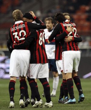 AC Milan's Ronaldinho (R) celebrates with his team mate David Beckham after a third goal against Genoa during their Italian Serie A soccer match at the San Siro stadium in Milan January 6, 2010.