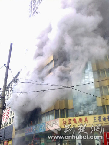 Smoke rises from a building located in Hanzheng street in Wuhan, capital city of central China's Hubei province, Friday, January 8, 2010. [Photo: cnhubei.com]