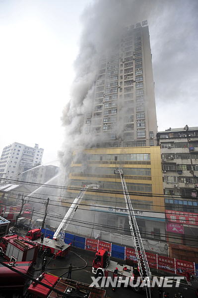 Smoke rises from a building located in Hanzheng street in Wuhan, capital city of central China's Hubei Province, Friday, January 8, 2010.