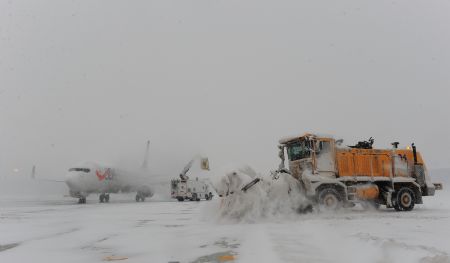 A snow-sweeping vehicle cleans snow at the Capital International Airport in Beijing, capital of China, Jan. 3, 2010. Some departure flights were delayed and some were canceled due to the heavy snowfall in Beijing on Sunday. [Xinhua]