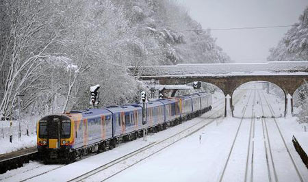 A train leaves station in Hampshire, a village 40 miles west of London January 6, 2009. [Xinhua/AFP]