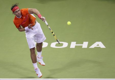 Spain's Rafael Nadal serves to Potito Starace of Italy during the ATP Qatar Open tennis tournament in Doha January 6, 2010. 