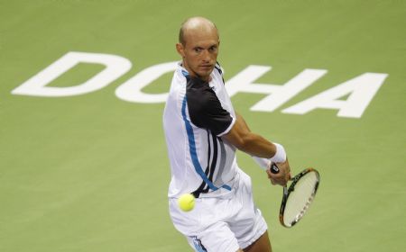 Russia's Nikolay Davydenko returns a shot to Spain's Rafael Nadal during the final match at the ATP Qatar Open tennis tournament in Doha January 9, 2010.