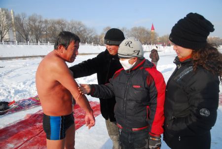 53-year-old Chen Kechai renders his cold-resistance stunt ability under the temperature of 10 more minus Celsius degrees to local citizens, in Mudanjiang, northeast China's Heilongjiang Province, Jan. 10, 2010.(Xinhua/Chen Zhanhui)