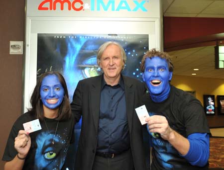 Director James Cameron (C) poses with movie goers Mahdroo McCaleb (R) and Sonjia Huirzar at a sold-out midnight screening of Cameron's new film 'Avatar: The IMAX 3D Experience' at the AMC 16 IMAX 3D theater in Burbank, California December 17, 2009 in this publicity photograph released December 18.