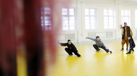 Chinese Shaoling martial arts enthusiasts attend their class with the master Shi Yanbin at the Russian Shaolin Martial Arts Learning Center in Moscow, capital of Russia, Jan. 10, 2010.