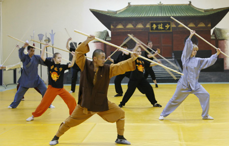 Chinese Shaoling martial arts enthusiasts attend their class with the master Shi Yanbin at the Russian Shaolin Martial Arts Learning Center in Moscow, capital of Russia, Jan. 10, 2010. 