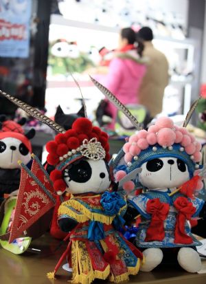 Photo taken on Jan. 10, 2010 show the cute Panda dolls in Peking Opera&apos;s makeup style, a novel doll brand series of Panda Town wrought by a group of young designers born after 1980s who returned to China after having finished education overseas, which is in limelight at a doll shop in Beijing. [Luo Wei/Xinhua]