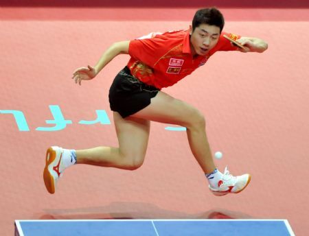 Xu Xin of China returns the ball to his compatriot Wang Liqin during the men's singles semifinal at the International Table Tennis Federation (ITTF) Pro Tour Grand Finals in Macao, south China, on Jan. 10, 2010. Xu was qualified for the final after beating Wang by 4-2. (Xinhua/Lo Ping Fai)