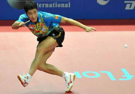 Wang Liqin of China returns the ball to his compatriot Xu Xin during the men's singles semifinal at the International Table Tennis Federation (ITTF) Pro Tour Grand Finals in Macao, south China, on Jan. 10, 2010. Wang lost the match 2-4. (Xinhua/Lo Ping Fai)  