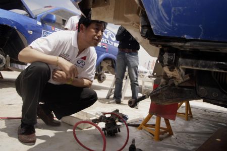 Lu Ningjun, Chinese rider for Rely Team, checks his car at the Dakar Rally camp at La Portada, near to Antofagasta, Chile on Jan. 9, 2010. Racers of Dakar Rally Argentina-Chile 2010 had a rest day. (Xinhua/Victor Rojas) 