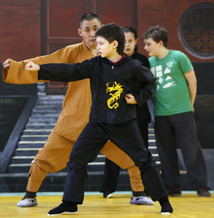 Chinese Shaoling martial arts enthusiasts attend their class with the master Shi Yanbin at the Russian Shaolin Martial Arts Learning Center in Moscow, capital of Russia, January 10, 2010. [Xinhua photo]