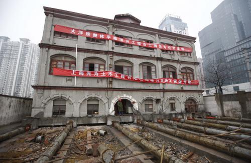 A century-old building in Pudong New District, Shanghai, is prepared for a move to make way for the construction of an Expo-related project, on Monday, January 11, 2010. [Photo: Xinhua]