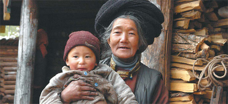 Erche Pinchu's mother and her grandson in front of their house in Lijiazui village.