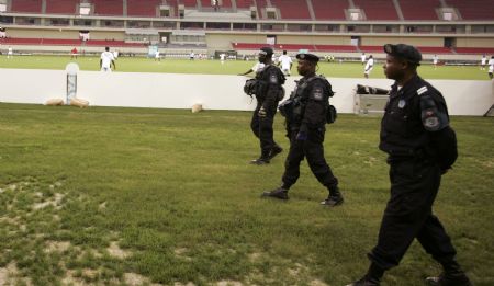 Policemen patrol the grounds during a training session by Burkina Faso's players before the start of their African Nations Cup Group B soccer match in Cabinda January 10, 2010. (Xinhua/Reuters Photo)