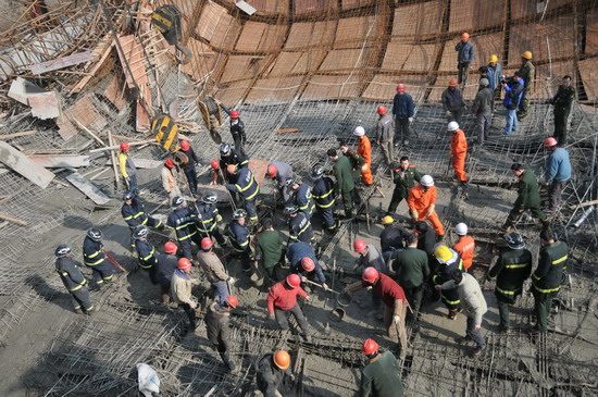 A rescue team searches for victims after a construction site scaffolding collapsed Tuesday, January 12, 2010, in Wuhu City, East China&apos;s Anhui Province. [Xinhua]