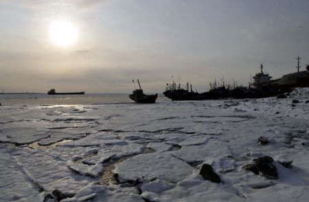 Fishing boats are seen in frozen Laizhou Bay, east China's Shandong Province, Jan. 12, 2010. The most severe icing situation in the past 30 years in the coast off Shandong Province continued to worsen amid cold snaps. Sea ice appeared last week along the coastline of the Bohai Sea and northern Yellow Sea as cold fronts pushed the temperature down to minus 10 degrees Celsius.