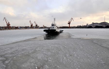 A tugboat sails in the frozen Laizhou Bay, east China's Shandong Province, Jan. 12, 2010. The most severe icing situation in the past 30 years in the coast off Shandong Province continued to worsen amid cold snaps. Sea ice appeared last week along the coastline of the Bohai Sea and northern Yellow Sea as cold fronts pushed the temperature down to minus 10 degrees Celsius.