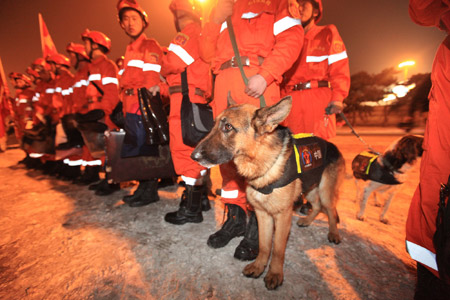 Members of a Chinese rescue team with sniffer dogs are ready to board a plane leaving for quake-hit Haiti, at the Capital International Airport in Beijing, capital of China, Jan. 13, 2010. A 7.0-magnitude earthquake hit Haiti on Tuesday local time, collapsing a hospital and damaging government buildings in its capital city of Port-au-Prince. (Xinhua/Xing Guangli)