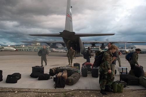 US soldiers unload gear as they arrive at Port-au-Prince&apos;s airport on January 13, 2009, one day after an eartquake measuring 7.0 hit the Haitian capital. More than 100,000 people were feared dead Wednesday after a cataclysmic earthquake struck Haiti, filling the streets with corpses and burying thousands under razed schools, hotels and hospitals. [Xinhua/AFP]