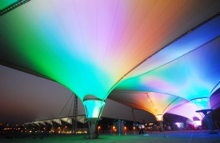 Photo taken on Jan. 12, 2010 shows the scenery of the Expo Axis during a trial illumination in the Expo Park in Shanghai, east China. Ninety percent of the construction work has been completed in the expo site by far. Workers are busy working to greet the 100 days count down to the opening of Shanghai World Expo on Jan. 21. (Xinhua Photo)