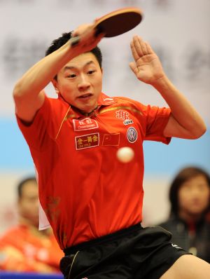 Shakehand player, China's Ma Long returns a shot against his compatriot Wang Hao, a Penhold player, during a table tennis charity competition between the Shakehand team and the Penhold team in Chengdu, capital of Southwest China's Sichuan Province, Jan. 14, 2010.