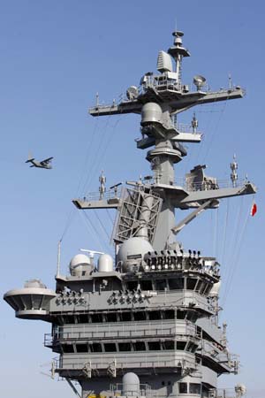 Sailors aboard the Nimitz-class aircraft carrier USS Carl Vinson (CVN 70) load pallets of relief supplies onto an MH-53E Sea Dragon helicopter as the ship arrives off the coast of Haiti January 15, 2010. [Xinhua] 