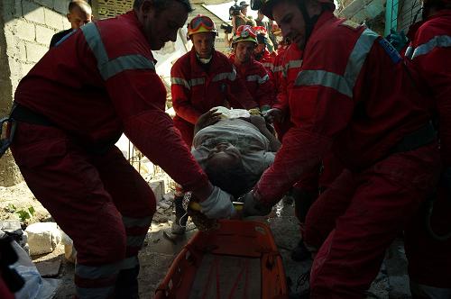 Rescuers from Belgium extract an injured woman from the rubble of her house, January 15, 2010 at Port Au Prince following the 7.0-magnitude quake on January 12. More than 50,000 people were killed and 250,000 injured by this week's earthquake, which also left nearly 1.5 million homeless, a Haitian minister said. After three days of Haitians being left to fend mostly for themselves in one of the world's poorest countries. 