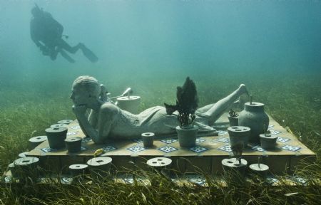 A diver swims near British artist Jason de Caires Taylor's sculpture 'The Flower of Hope' in this undated handout in the Mexican resort of Cancun.