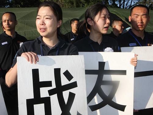 Chinese police officers are in tears when they bid farewell to their colleagues who died in the Haiti quake in Port-au-Prince, capital of Haiti, January 17, 2010. [Xinhua]