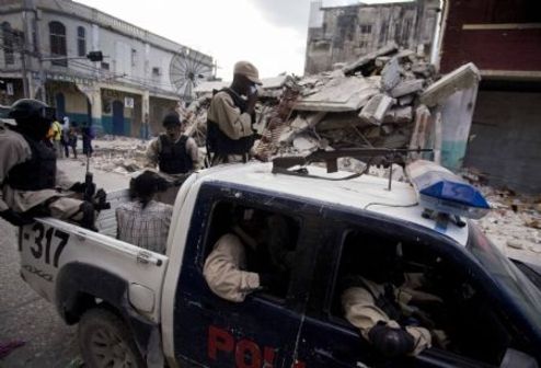 Haitian police patrol at a street in Haitian capital Port-au-Prince on Jan. 16, 2010. The situation in Haiti is worsened by occasional looting in the aftermath of a devastating earthquake on Jan. 12. (Xinhua/David de la Paz)