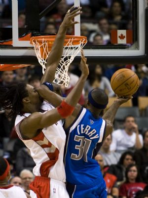 Dallas Mavericks guard Jason Terry (R) fouls Toronto Raptors forward Chris Bosh while going to the basket during the second half of their NBA basketball game in Toronto January 17, 2010.