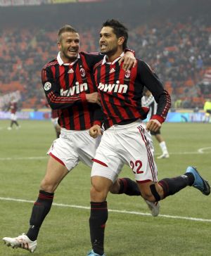 AC Milan's Marco Borriello (R) celebrates with his team mate David Beckham after scoring against Siena in their Italian Serie A soccer match at San Siro stadium in Milan, January 17, 2010. 