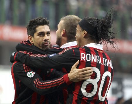 AC Milan's Marco Borriello (L) celebrates with his team mates Ronaldinho (R) and David Beckham after scoring against Siena in their Italian Serie A soccer match at San Siro stadium in Milan, January 17, 2010. 