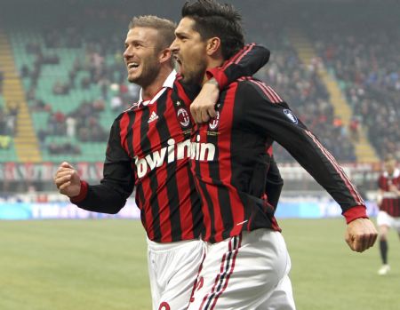 AC Milan's Marco Borriello (R) celebrates with his team mate David Beckham after scoring against Siena in their Italian Serie A soccer match at San Siro stadium in Milan, January 17, 2010.